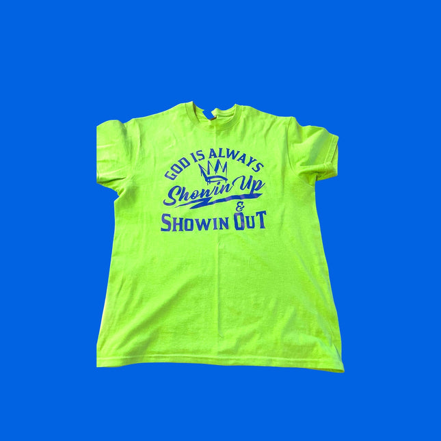 Bright neon green t-shirt featuring the text "God is always ready to show up and show out" prominently displayed.
