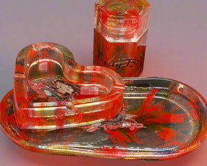 A set of custom-designed items including a rolling tray, canister, ashtray, and carrying bag with red and black colors and Betty Boop character illustrations.