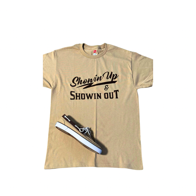 A graphic t-shirt with the text "Showing Up & Showing Out" prominently printed in eye-catching colors.