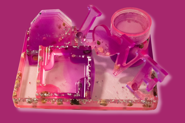 Pink and clear plastic toy set on a pink background