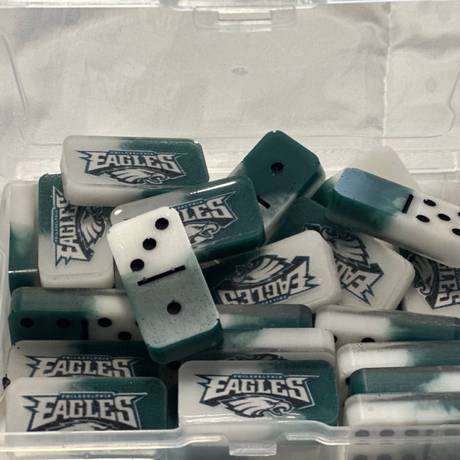 Set of dominoes with Eagles logo in a clear plastic container on a white background